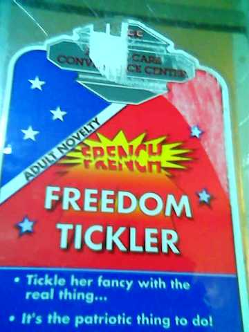 bathroom condom machine labeled ''>french< FREEDOM TICKLER - Tickle her fancy with the real thing... - It's the patriotic thing to do!''